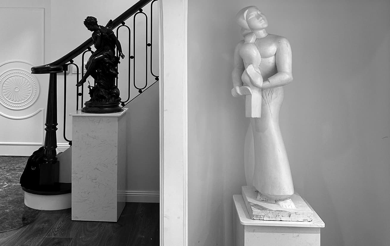 Museum gallery interior with classical sculptures and elegant architecture